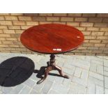 A circular tilt-top mahogany table,