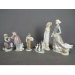 A collection of Spanish porcelain figurines to include Lladro, Nao and similar,