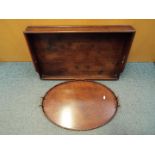 A butlers serving tray 69 cm x 44 cm and one other having brass handles.