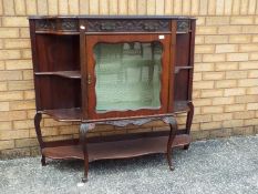 A side unit with central glazed display section flanked either side by shelving,