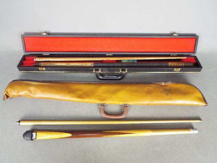 Two pool cues comprising a BCE two piece example and similar,