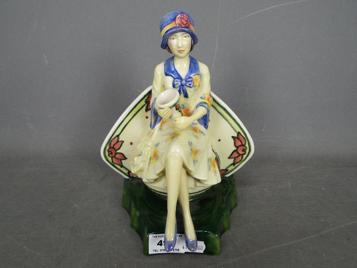 A Kevin Francis limited edition figurine depicting Charlotte Rhead seated and holding a vase,