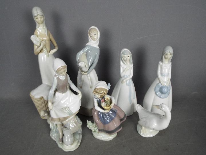 Seven Spanish porcelain figurines to include Lladro, Nao and similar,