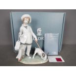 Lladro - A boxed figurine # 8522 Girl With French Bulldog depicting a young girl with shopping bags