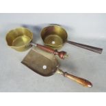 A vintage brass sauce pan with wooden handle and a brass sauce pan with brass shovel Lot