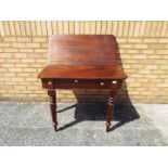 A late Georgian / early Victorian D-end flip top mahogany dining table on tapering turned supports,
