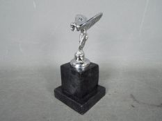 A chrome flying lady set on a marble plinth ,