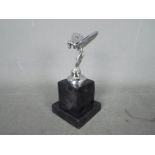 A chrome flying lady set on a marble plinth ,