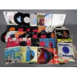 A collection of 7" vinyl records to include David Bowie, The Kinks, The Who,