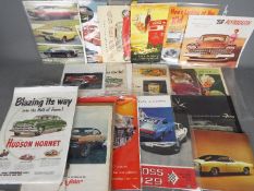 A collection of magazine cuttings / advertising materials, automotive and Coca Cola related.