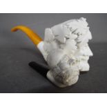 Two meerschaum pipes, the larger example modelled as Bacchus.