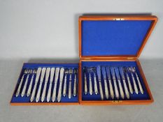 A wooden cased canteen of cutlery.