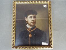 A small oil on board portrait depicting a lady in period dress, framed under glass,