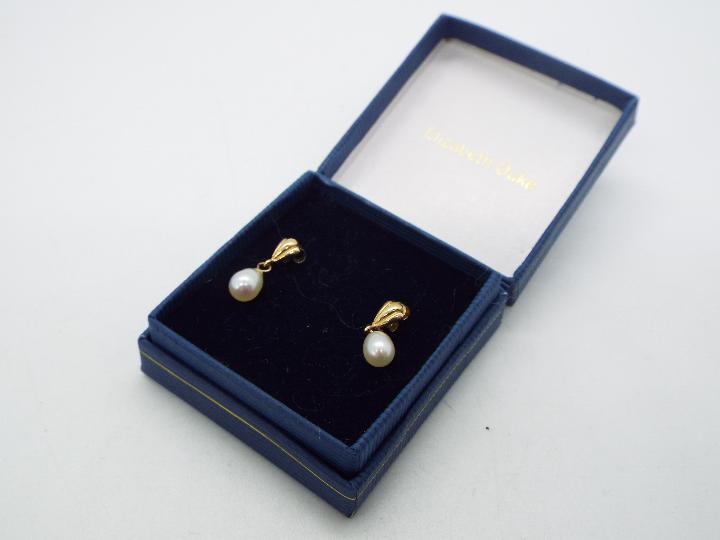 A pair of pearl drop earrings, butterflies stamped 9ct, approximately 1 gram all in. - Image 2 of 2