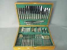 An oak cased canteen of hallmarked silver cutlery for eight settings (the fish knives have silver