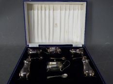 A hallmarked silver six piece cruet set contained in fitted case, Birmingham assay,