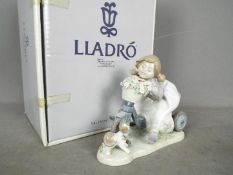 Lladro - A boxed Lladro figurine # 5679 In No Hurry, depicting a young girl on a tricycle,