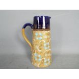 Doulton - a ceramic and pewter jug,