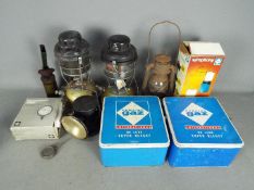 Lot to include vintage camping stoves, oil lamps and an Acme powder blower.