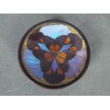 A small, butterfly wing, trinket or ring dish raised on tripod supports,