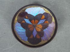 A small, butterfly wing, trinket or ring dish raised on tripod supports,