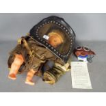 Two World War Two (WW2) British issue Gas Masks comprising a Baby's Gas Mask with full view window