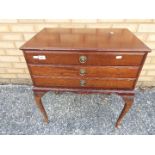 A mahogany three-drawer cabinet containing a good quantity of Walker & Hall cutlery,