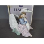 Lladro - A boxed figural group entitled Swan Song, # 5704, approximately 18 cm (h).