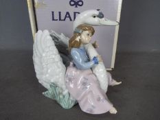 Lladro - A boxed figural group entitled Swan Song, # 5704, approximately 18 cm (h).