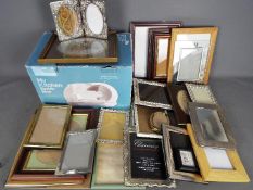 Thirty Picture frames of various sizes and a kitchen slicer.
