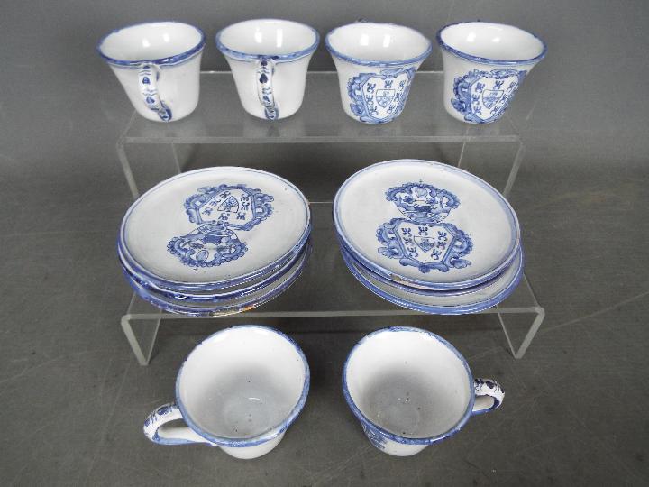 Six blue and white coffee cans and saucers depicting the coat of arms of Joao V of Portugal (Sun