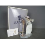 Lladro - A boxed figurine # 6093 'Songbird', depicting a young girl playing the flute,