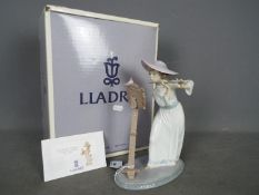 Lladro - A boxed figurine # 6093 'Songbird', depicting a young girl playing the flute,