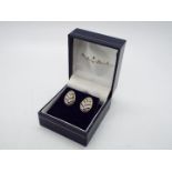 A pair of 14ct and diamond earrings, approximately 2.7 grams all in.