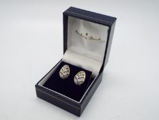 A pair of 14ct and diamond earrings, approximately 2.7 grams all in.