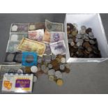 A collection of foreign and UK coins and banknotes.