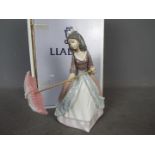 Lladro - A boxed figurine entitled Jolie, # 5210, depicting a young girl holding a parasol,