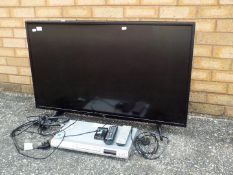 An LG flat screen television set model 43UH610V, and a dvd player,