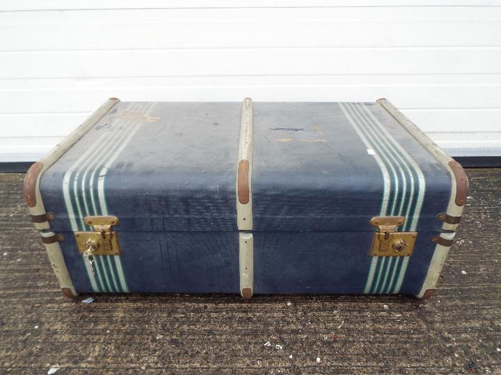 A vintage, wood bound shipping trunk.