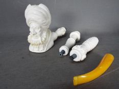 A large, sectional, meerschaum pipe, carved in the form of a bearded gentleman.