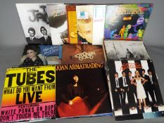 Approximately sixty five 12" vinyl records to include The Jam, Michael Jackson, Billy Idol,