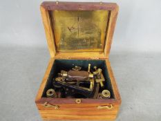 A brass nautical sextant marked 'Kelvin & Hughes, London 1917', contained in fitted box.