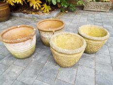 Two matched pairs of circular garden planters,