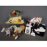 Four 'Cow Parade' figures, one contained in original box, largest approximately 15 cm (h).