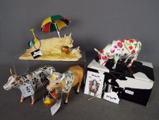 Four 'Cow Parade' figures, one contained in original box, largest approximately 15 cm (h).