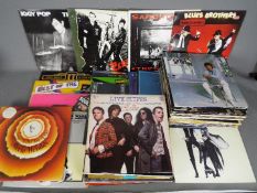 A good collection of 12" vinyl records to include The Clash, Iggy Pop, Pretenders, Gary Numan,