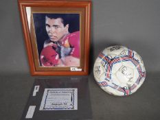 A framed photographic print of Muhammad Ali, bearing signature, with certificate of authenticity,