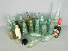 A collection of antique and later glass bottles,