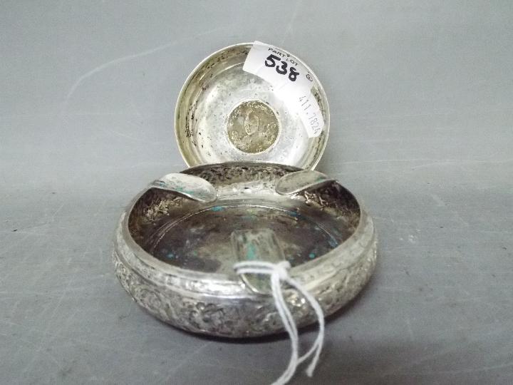 A small Iranian / Persian silver bowl with chased decoration and a similar ashtray,