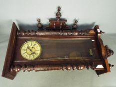 A Vienna styled wall clock, the case having turned and carved decoration,